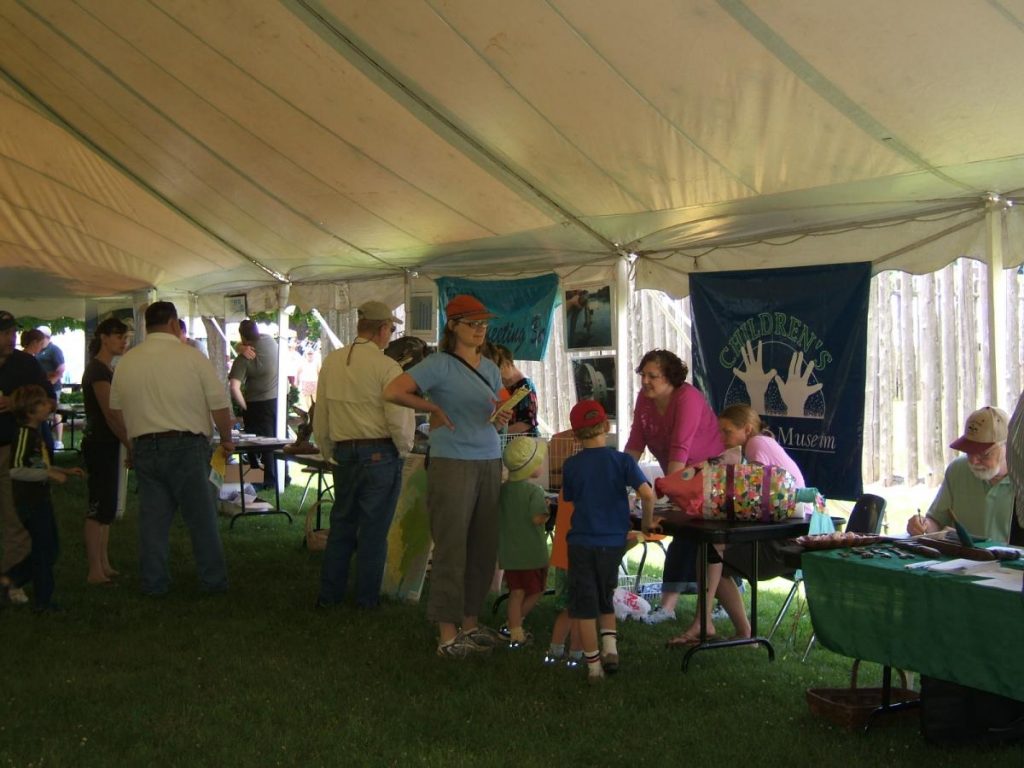 photo of people at information displays inside a tent