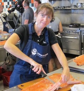 The author filets a salmon in the kitchen of Johnson & Wales.