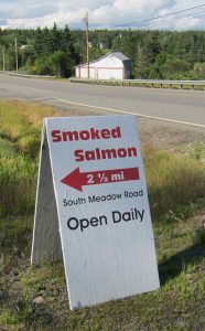 photo of sign reading _fresh crabmeat, live lobster, cherrystones, mussels, clams