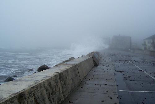 A storm with waves overcoming a barrier