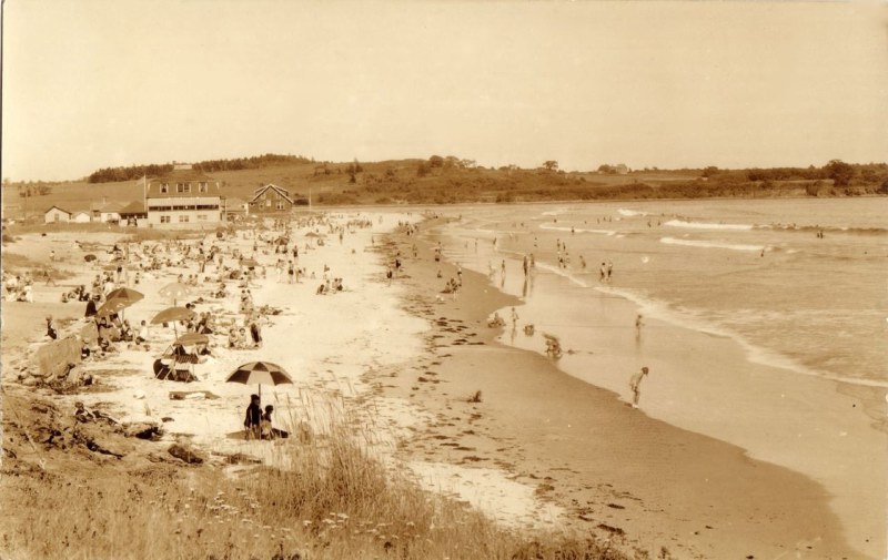 sepia-tone photo of sunbathers and swimmers enjoying Higgins Beach in the 1930s