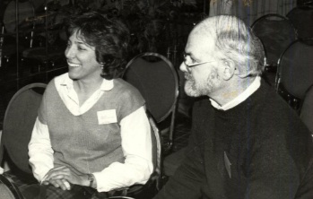 Black and white image of Robin Alden and unidentified man sitting at the Forum