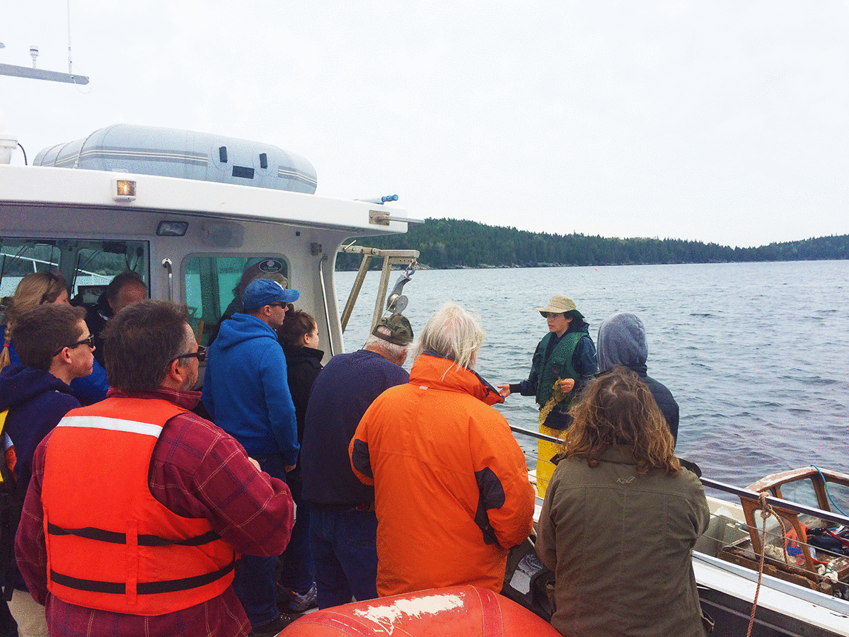 Sarah Redmond addressing a group of students on a boat