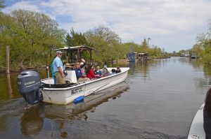 several people aboard a small boat on the water