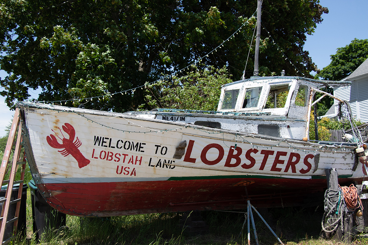 an out of the water lobster boat with decorative paint