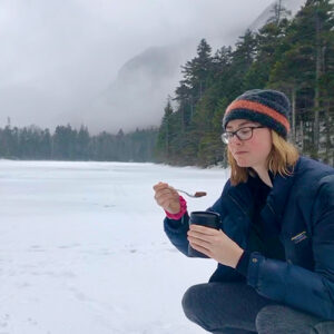 Lucie Nolden crouching on snowy ground