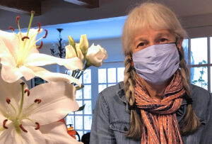 Masked photo of Esperanza Stancioff sitting beside flowers