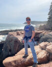 David Carter standing on a rocky beach