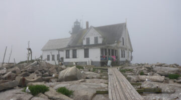 House in fog on granite ledge, foggy background