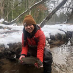 Sara Ang holds a fish in winter waters