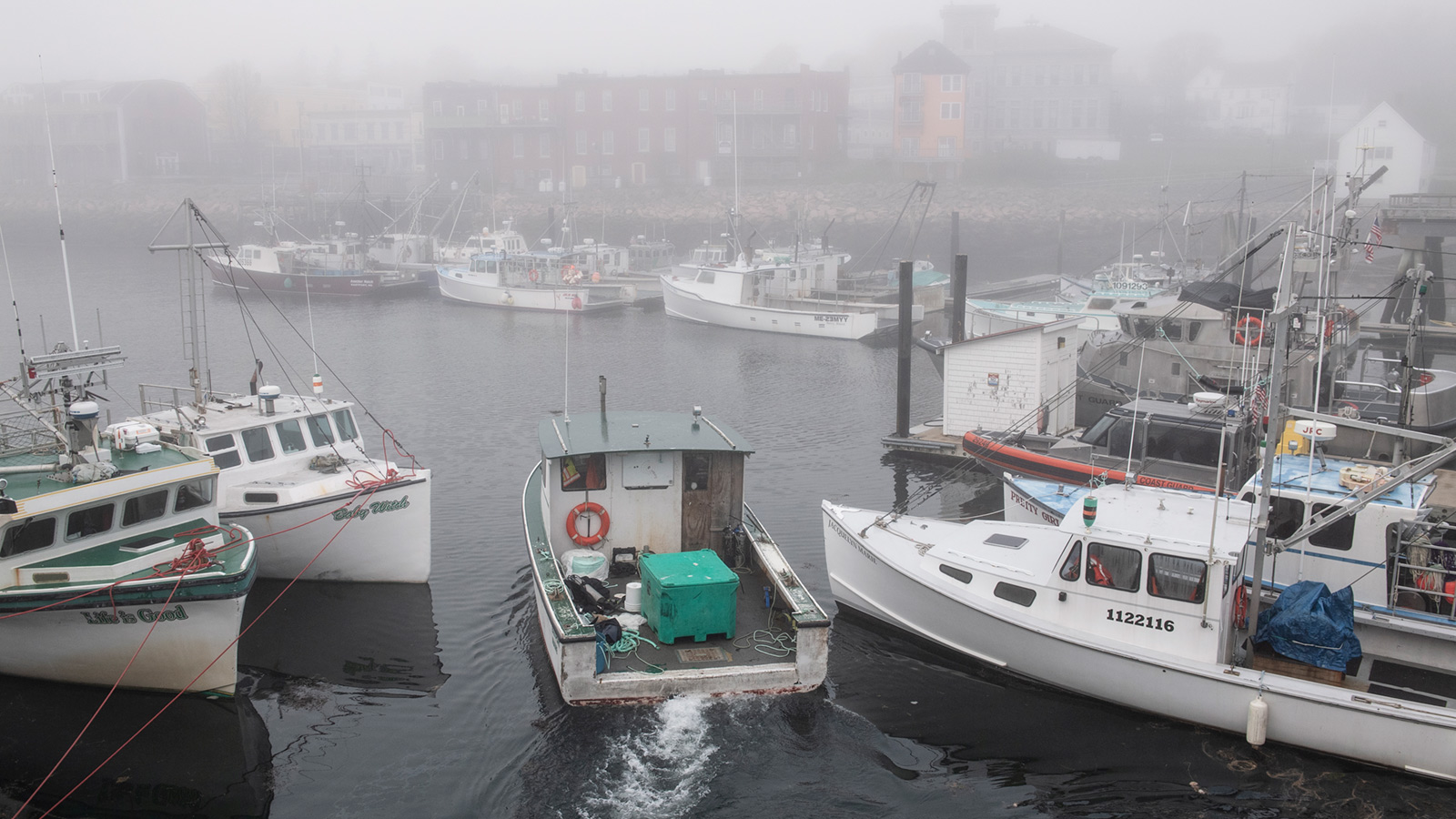 Boats in a foggy harbor