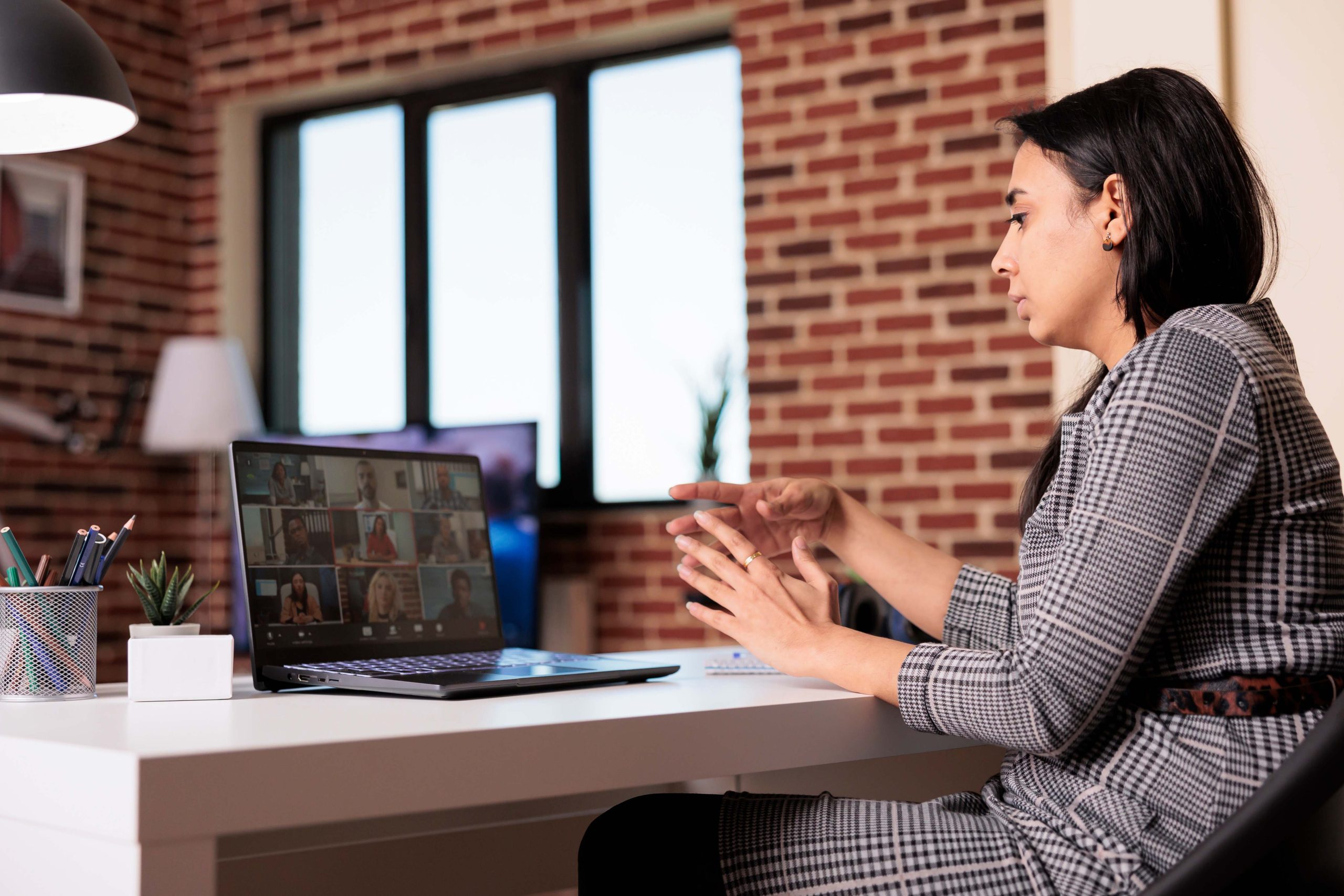 Young worker using remote videocall meeting to talk to colleagues on virtual conference with webcam. Chatting on online videoconference call, having internet conversation on teleconference.