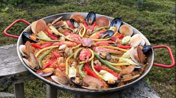 a wide dish of colorful paella