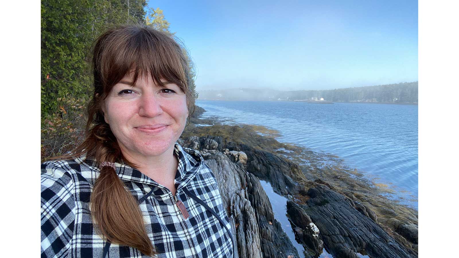 headshot of Jessica Brunacini with shore in the background