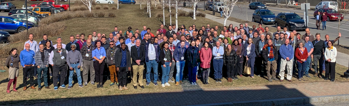 an outside group photo of symposium attendees