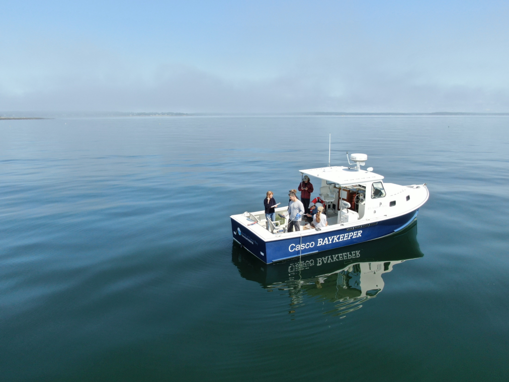 The 'Casco Baykeeper' vessel floats in open water with researchers aboard.